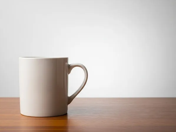 Clean product composition with negative space example — mug placed on the left third with large empty space for ad copy, creating a minimal commercial layout suitable for ecommerce and advertising (after busy product layout).
